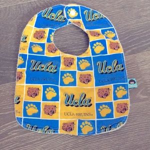 UCLA baby bib. Snap closure. Minor blemish on front. Soft material on backing.